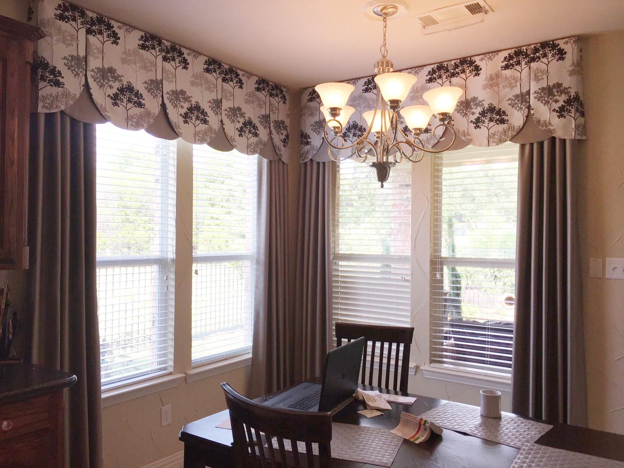 Living room with blinds and patterned drapery